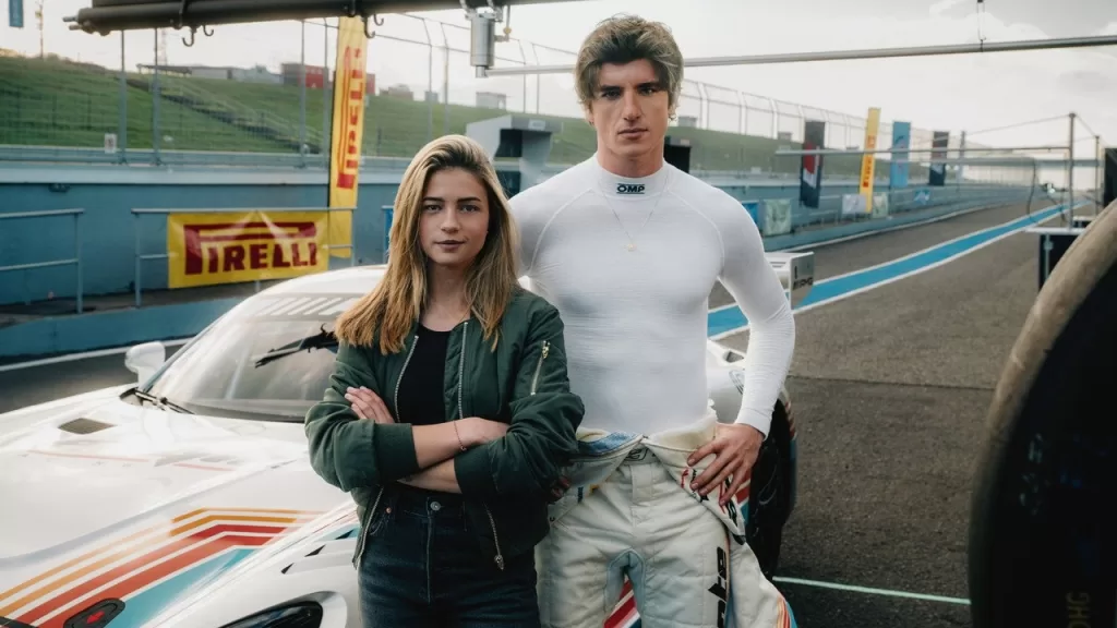 Lisa-Marie Koroll e Amin Baahmed, protagonistas de Velocidade e Paixão, lado a lado na área dos boxes de um autódromo em imagem de divulgação do filme
